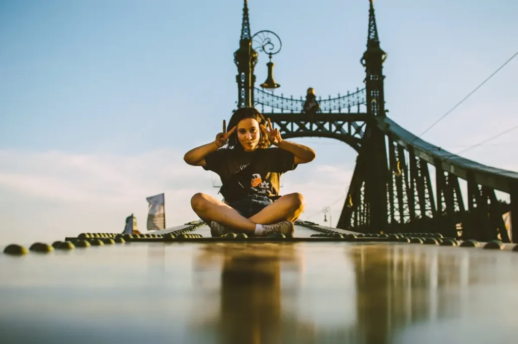 A young Tourist on a bridge as a Sitting Pose Reference