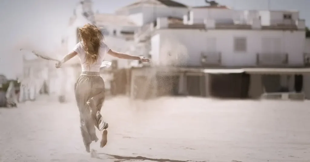 woman running through sand as a female pose reference