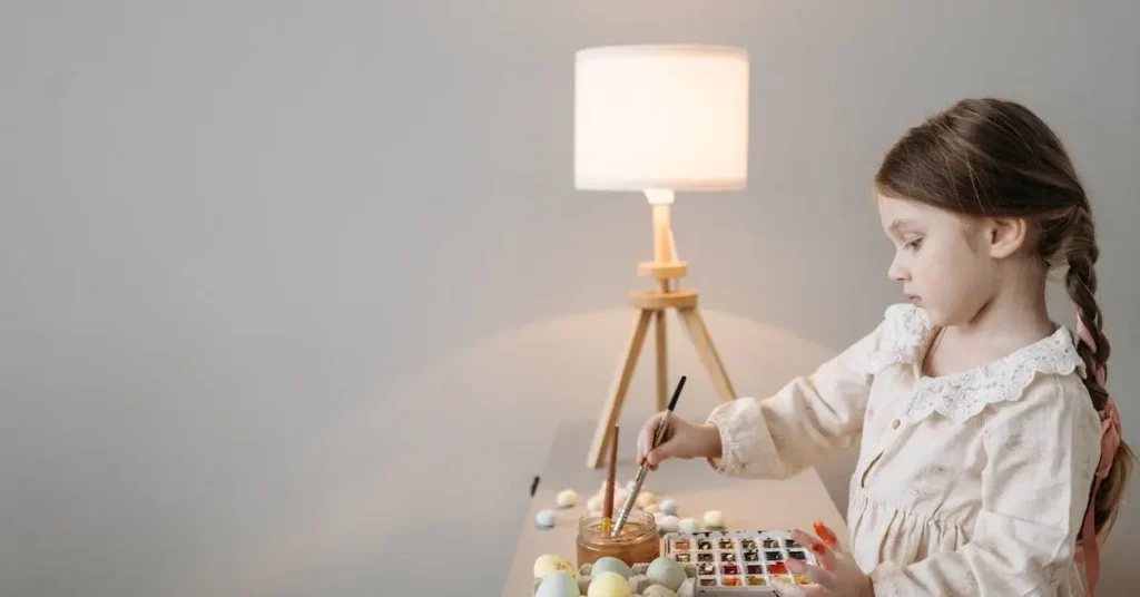 a girl painting eggs as easter drawing ideas
